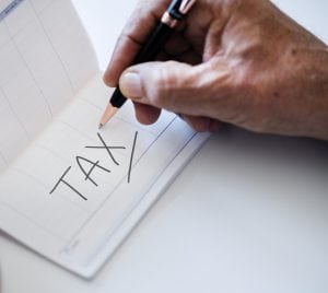 Man writing taxes on a checkbook